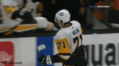 A Hockey Player With The Number 71 On His Jersey Stands On The Ice GIF