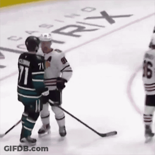 A Hockey Player With The Number 71 On His Jersey Talks To Another Player GIF