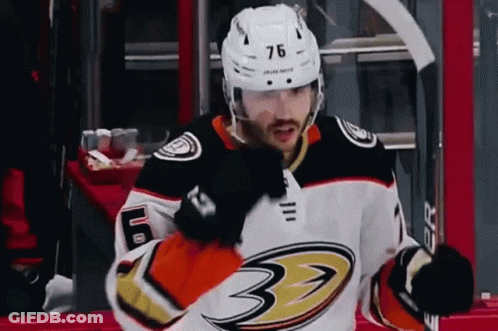 A Hockey Player With The Number 76 On His Helmet Is Standing On The Ice GIF