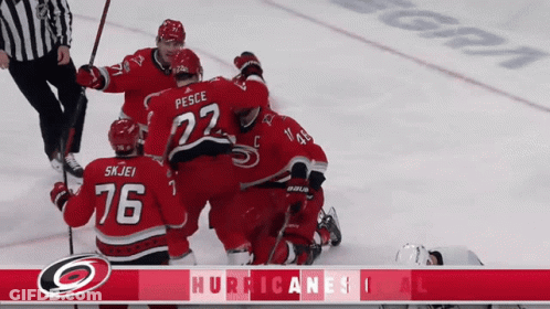 A Hockey Player With The Number 76 On His Jersey Is Surrounded By His Teammates GIF