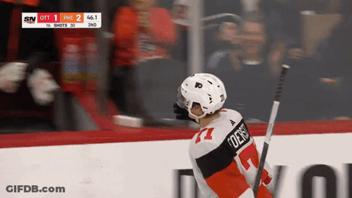 A Hockey Player With The Number 77 On His Jersey Is Holding A Hockey Stick GIF