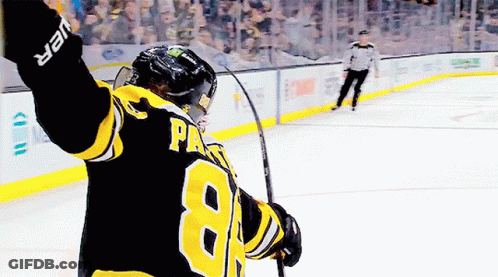 A Hockey Player With The Number 8 On His Jersey Is Holding A Hockey Stick GIF