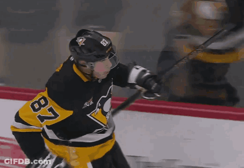 A Hockey Player With The Number 87 On His Jersey Is Holding A Hockey Stick GIF