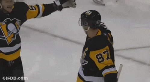 A Hockey Player With The Number 87 On His Jersey Stands On The Ice GIF