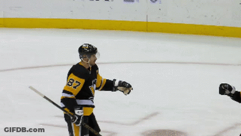 A Hockey Player With The Number 87 On His Jersey Talks To Another Player GIF