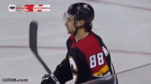 A Hockey Player With The Number 88 On His Back Stands On The Ice GIF