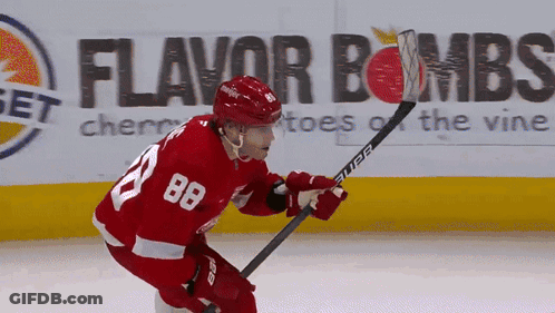 A Hockey Player With The Number 88 On His Jersey Is Holding A Hockey Stick GIF