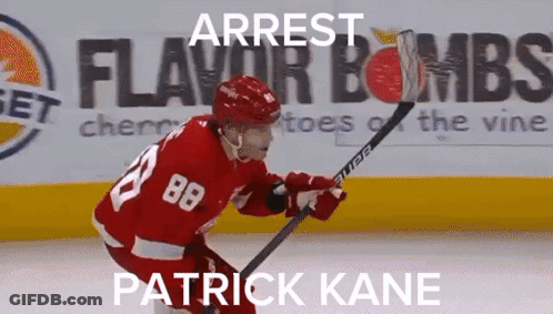 A Hockey Player With The Number 88 On His Jersey Is Holding A Hockey Stick GIF