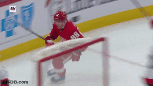 A Hockey Player With The Number 88 On His Jersey Is Skating On The Ice GIF