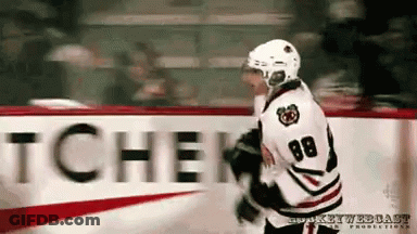 A Hockey Player With The Number 88 On His Jersey Stands In Front Of A Sign That Says Tchen GIF