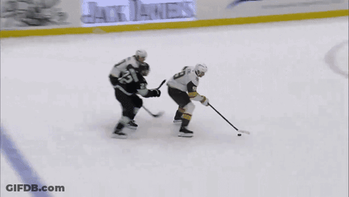 A Hockey Player With The Number 9 On His Jersey Stands On The Ice GIF