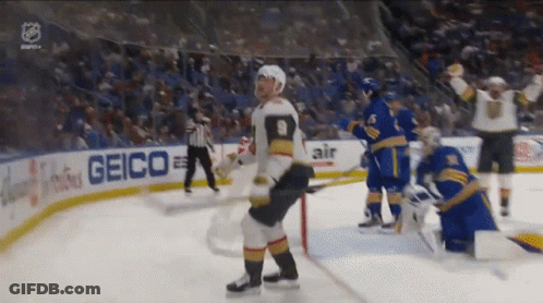 A Hockey Player With The Number 9 On His Jersey Stands On The Ice GIF