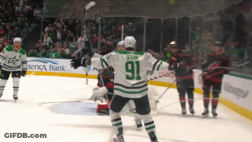 A Hockey Player With The Number 91 On His Jersey Stands On The Ice GIF