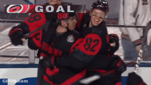 A Hockey Player With The Number 92 On His Jersey Is Hugging Another Player GIF