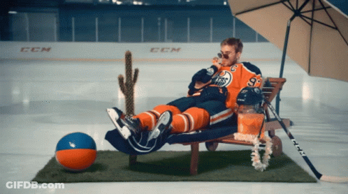 A Hockey Player With The Number 93 On His Jersey Is Laying On A Beach Chair GIF