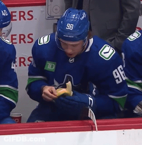 A Hockey Player With The Number 96 On His Jersey Eating A Snack GIF