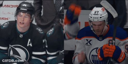 A Hockey Player With The Number 97 On His Helmet Stands Next To Another Player GIF