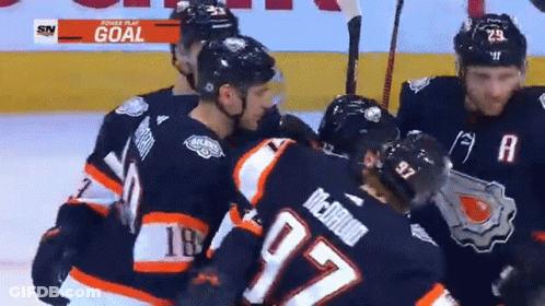 A Hockey Player With The Number 97 On His Jersey Is Hugging Another Player GIF