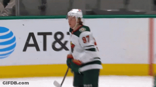 A Hockey Player With The Number 97 On His Jersey Is On The Ice GIF