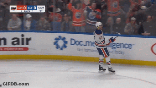 A Hockey Player With The Number 97 On His Jersey Is Standing On The Ice GIF