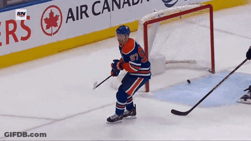 A Hockey Player With The Number 97 On His Jersey Stands On The Ice GIF