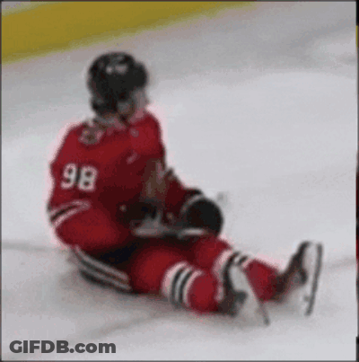 A Hockey Player With The Number 98 On His Back Is Laying On The Ice GIF