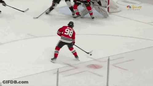 A Hockey Player With The Number 98 On His Back GIF