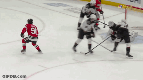 A Hockey Player With The Number 98 On His Jersey Is Kneeling On The Ice GIF