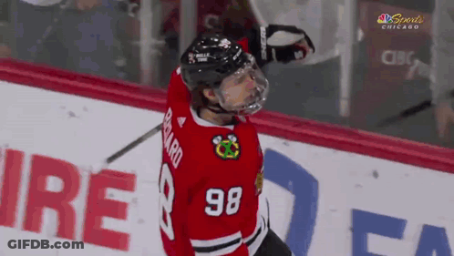 A Hockey Player With The Number 98 On His Jersey Stands On The Ice GIF