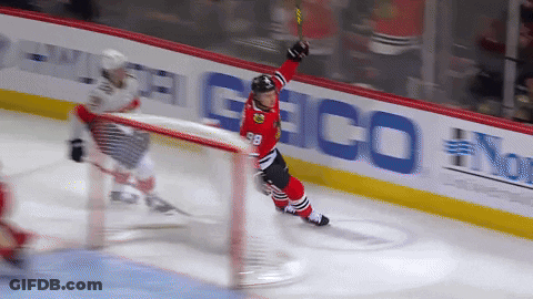 A Hockey Player With The Number 98 On His Jersey Stands On The Ice GIF