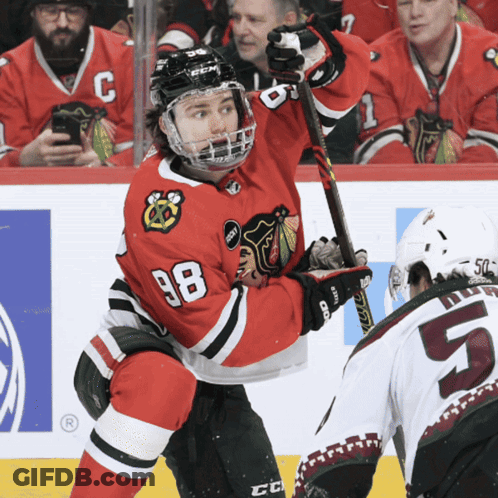 A Hockey Player With The Number 98 On His Shirt GIF