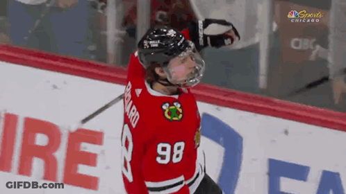 A Hockey Player With The Number 98 On His Shirt GIF
