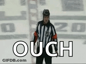 A Hockey Referee Is Standing On The Ice With The Word Ouch In Front Of Him GIF