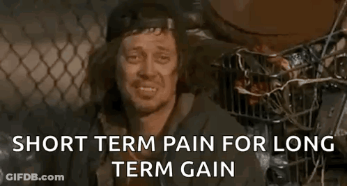 A Homeless Man Is Sitting In A Cage With The Words `` Short Term Pain For Long Term Gain '' Written Above Him . GIF