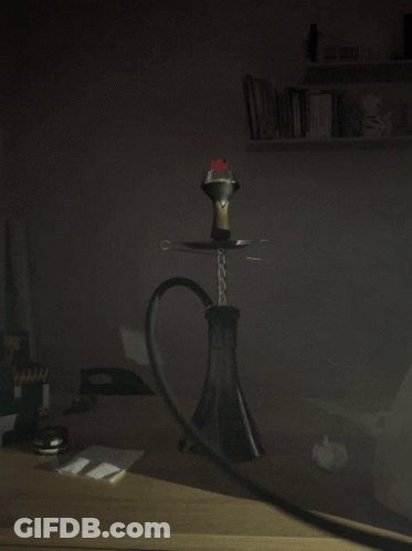A Hookah With Smoke Coming Out Of It Is On A Table In The Dark GIF