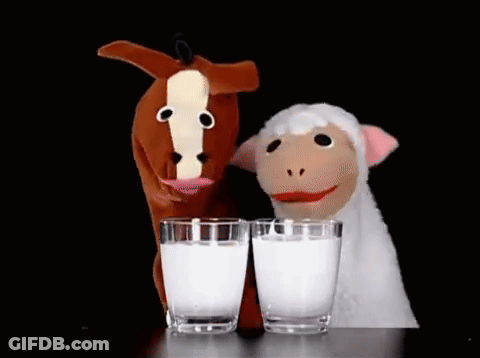 A Horse Puppet And A Sheep Puppet Are Drinking Milk From Glasses GIF