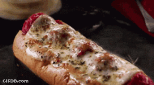 A Hot Dog On A Bun With Cheese On It GIF