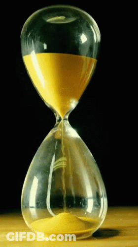 A Hourglass With Yellow Sand Coming Out Of It Against A Black Background GIF