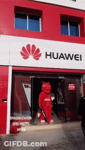 A Huawei Store Has A Red Dragon Mascot In Front Of It GIF