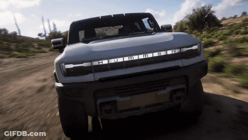 A Hummer Is Driving Down A Dirt Road In The Desert GIF