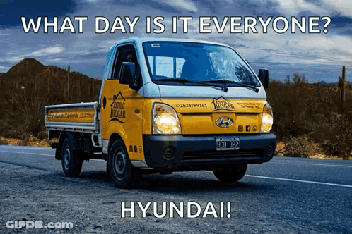 A Hyundai Truck Is Driving Down The Road GIF