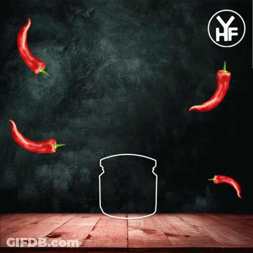 A Jar Of Chilli Paste Sits On A Wooden Table With Red Peppers Around It GIF