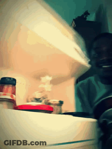 A Jar Of Tomato Sauce Sits On A Shelf In A Kitchen GIF
