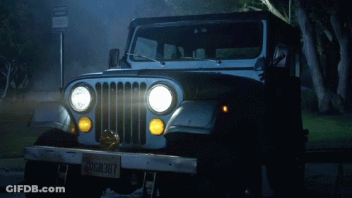 A Jeep Is Parked In Front Of A Sign That Says No Parking GIF