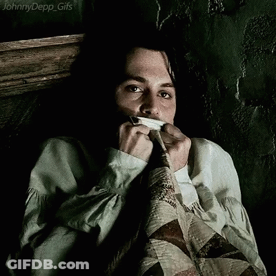 A Johnny Depp Gif Shows A Man Covering His Mouth With A Piece Of Cloth GIF