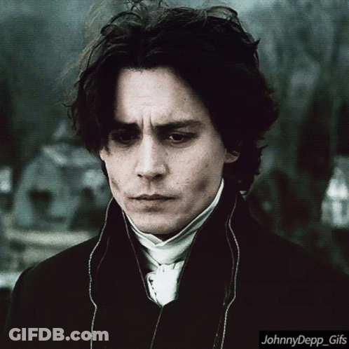A Johnny Depp Gif With A Man In A Suit And Tie GIF