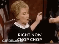 A Judge Is Sitting At A Table In A Courtroom Giving A Thumbs Down Sign . GIF