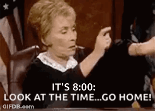 A Judge Is Sitting At A Table In A Courtroom Pointing At Someone . GIF