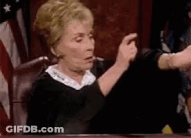 Judge Making Funny Face In Court With American Flag GIF