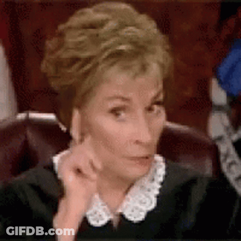 A Judge Is Sitting In A Chair With Her Hand On Her Face . GIF